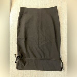 Juniors size 7/8 black stretchy pencil skirt with bow tie details at bottom hem